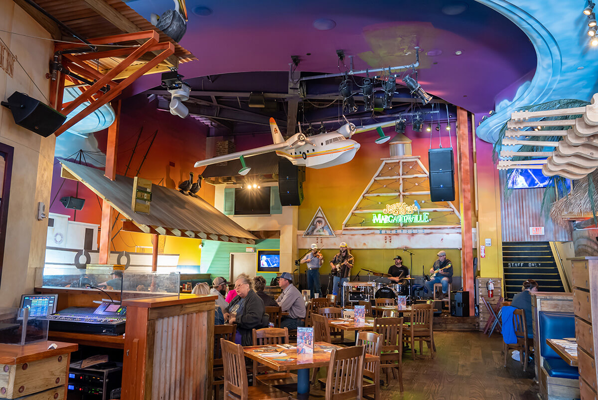 Conky Tonkin' Dining with large stage, plenty of seating and airplane hanging overhead